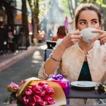 Young,Stylish,Woman,,Fashion,Sunglasses,,Sitting,In,Cafe,,Holding,Drinking