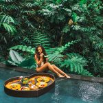 Girl,Relaxing,And,Eating,Floating,Breakfast,In,Jungle,Pool,On